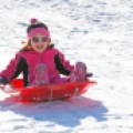 Kinley Sellden, 3, of West Fargo, N.D. giggles as she flies down the sledding hill at Rendezvous Park on Sunday, January 18, 2015. "It' so fun," she exclaimed after stopping at the bottom. Carrie Snyder / The Forum