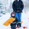 Two-year-old Griffin Krush grunts as he clears a path for his mom, Joan, while shoveling along 32nd Avenue in north Fargo, N.D. on Tuesday, December 1, 2015. Carrie Snyder / The Forum