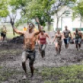 Runners trudge through the mud during the Hard Charge race at the Red River Valley Fairgrounds in West Fargo, N.D. on Saturday, June 14, 2014. Carrie Snyder / The Forum