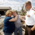 Sheriff Mike Carr, right, comforts sisters Geralyn Petersen, left, and Jonell Asfeld who lost her southwest Wadena, Minn. home in Thursday's tornado. Carrie Snyder / The Forum